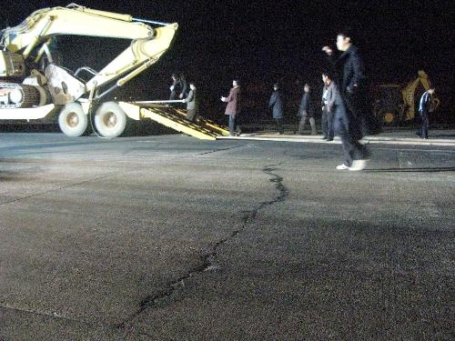 People work on a runway with cracks caused by severe drought at Kunming Airport, southwest China's Yunnan Province, March 18, 2010.