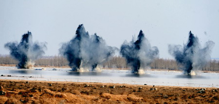 Explosions successfully break the ice of the dangerous Minjibu Reach of the Yellow River under the bombardment in Tumd Right Banner of north China&apos;s Inner Mongolia Autonomous Region on March 22, 2010. 