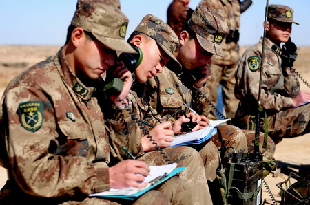 Soldiers observe the point of the explosion position for the blasts on the ice of the dangerous Minjibu Reach of the Yellow River under the bombardment in Tumd Right Banner of north China&apos;s Inner Mongolia Autonomous Region on March 22, 2010.