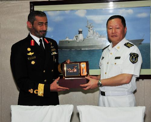 Qiu Yanpeng (R), commander of the fourth Chinese Navy Escort Task Group, presents a souvenir to the United Arab Emirates (UAE) Navy Rear Admiral Sheikh Saeed bin Hamdan Al Nahyan at a welcoming ceremony in honour of the Chinese Navy Escort Task Group in Abu Dhabi, capital of the UAE, March 24, 2010.