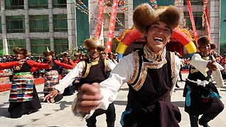 Local residents dance during a celebration for the upcoming Serfs Emancipation Day in Zhanang County, southwest China's Tibet Autonomous Region, March 26, 2010.