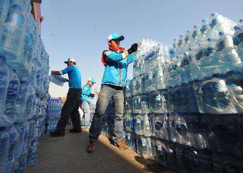 Vounlunteers count and sort the donations at a donation site at Fengtai Sports Center in Beijing, China, March 28. 2010. 