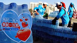 Vounlunteers load the donations at a donation site in Fengtai Sports Center in Beijing, China, March 28. 2010. Nearly 470,000 bottles of water, which have been collected during a public donation campaign held in Beijing recently, now is head for the drought-hit southwestern provinces in China on Sunday.