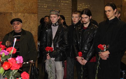 People place flowers in memory of the bomb victims at the Cultural Park subway station in Moscow, capital of Russia, March 29, 2010. 