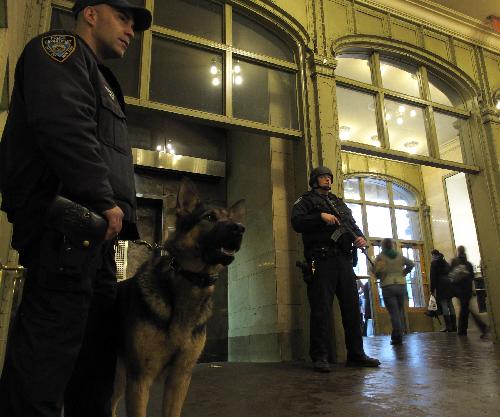 Police officers of the New York Police Department (NYPD) stand guard at the Grand Central Station in New York, the United States, March 29, 2010. 