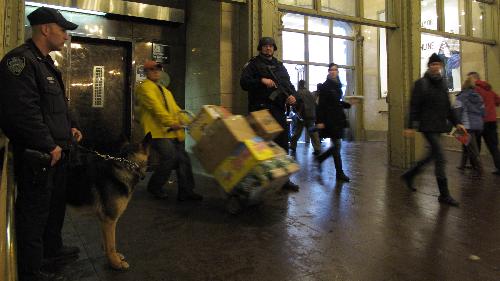 Police officers of the New York Police Department (NYPD) stand guard at the Grand Central Station in New York, the United States, March 29, 2010. 