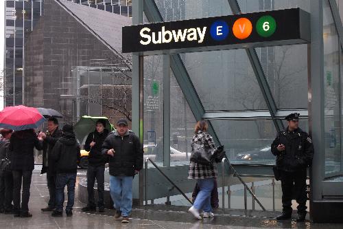  police officer of the New York Police Department (NYPD) stands guard outside a subway station in New York, the United States, March 29, 2010. 