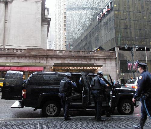 Police officers of the New York Police Department (NYPD) stand guard outside the Grand Central Station in New York, the United States, March 29, 2010.