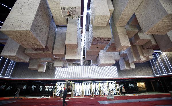 Workers put final touches to decorations in China Pavilion at World Expo site in Shanghai, east China, March 30, 2010. 