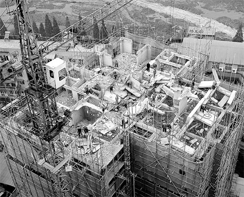 Workers demolish a 20-story building that was illegally built in Wuhan, Hubei Povince, in this Nov 26, 2009 file photo.