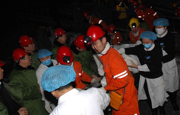 A rescued miner is carried out of a shaft at Longpeng Coal Mine in Qitaihe City, northeast China's Heilongjiang Province, on April 6, 2010. 