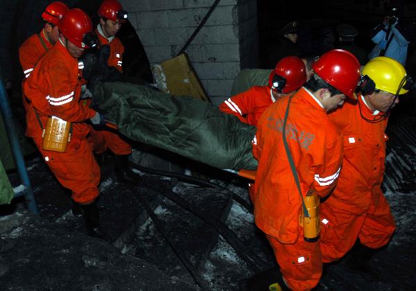 A rescued miner is carried out of a shaft at Longpeng Coal Mine in Qitaihe City, northeast China's Heilongjiang Province, on April 6, 2010. 