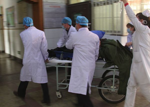 A rescued miner from the flooded Wangjialing Coal Mine is taken to the Renmin Hospital in Hejin City in north China's Shanxi Province, on April 5, 2010. The Renmin Hospital took 48 survivors from the mine and planed to take another 12 survivors from the mine. 