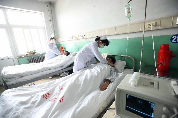 Rescued miners of the flooded Wangjialing Coal Mine receive treatment at Hejin People's Hospital in Hejin, north China's Shanxi Province, April 6, 2010.