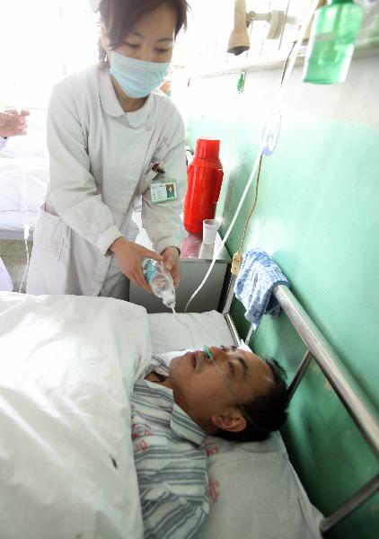 Wang Hongming, a rescued miner of the flooded Wangjialing Coal Mine, receives treatment at Hejin People&apos;s Hospital in Hejin, north China&apos;s Shanxi Province, April 6, 2010.