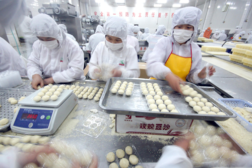 Workers make sesame balls and dumplings on Tuesday in a Henan factory authorized to produce food for the Shanghai Expo.