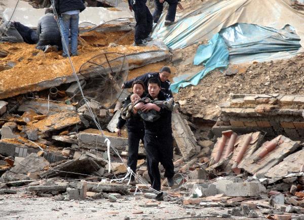 Police and people succor a child from the debris of crumbled houses shortly after an earthquake jolted at 7:49 AM, at Gyegu Town, of Yushu, a Tibetan autonomous prefecture in western Qinghai Province of northwest China, April 14, 2010.