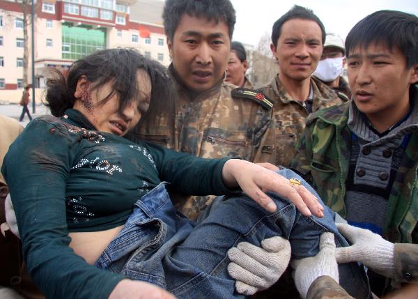 An injured woman is rescued after a quake in Yushu County, northwest China's Qinghai Province, April 14, 2010.