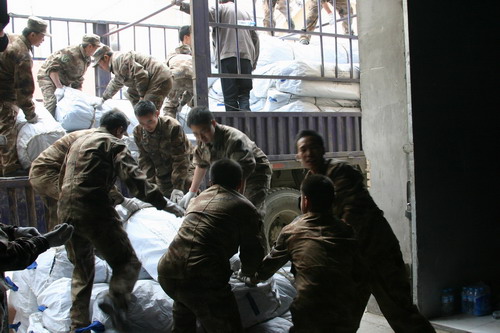 Rescue relief materials to quake-hit Yushu are packed on trucks by Qinghai Bureau of Civil Affairs on April 14, 2010.