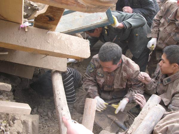 Officers and soldiers of the Chinese People's Liberation Army work in a rescue operation in the rubbles of destroyed houses in Yushu County, northwest China's Qinghai Province, April 14, 2010. 
