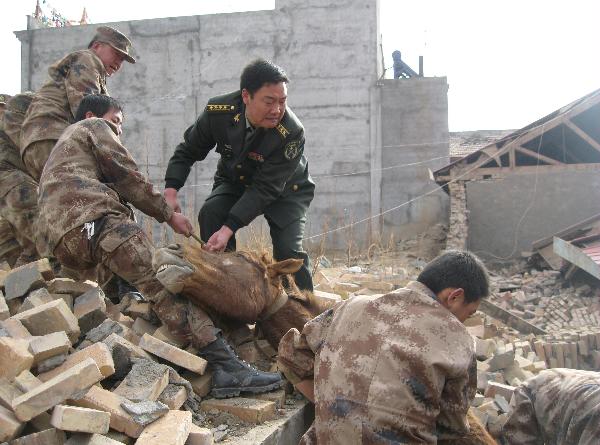 Officers and soldiers of the Chinese People's Liberation Army work in a rescue operation in the rubbles of destroyed houses in Yushu County, northwest China's Qinghai Province, April 14, 2010. 
