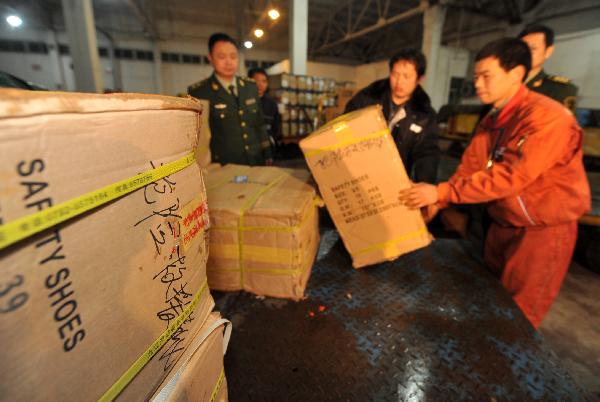 Workers load relief materials at an airport in Nanchang, capital of east China's Jiangxi Province, April 14, 2010.