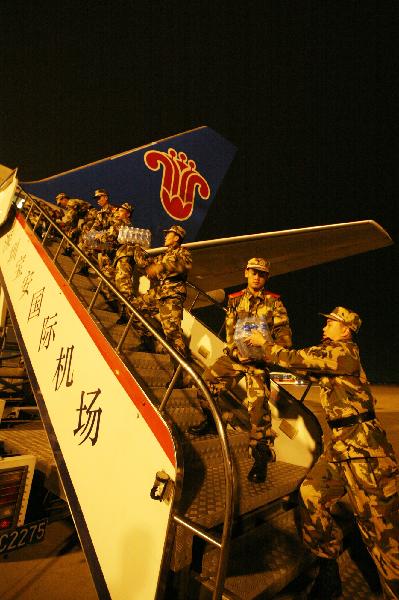 Rescuers load relief materials onto the plane at Bao'an Airport in Shenzhen, south China's Guangdong Province, April 14, 2010. 