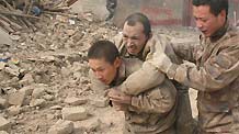 Soldiers of the Chinese People's Liberation Army rescue a survivor of quake in Yushu County, northwest China's Qinghai Province, April 14, 2010.