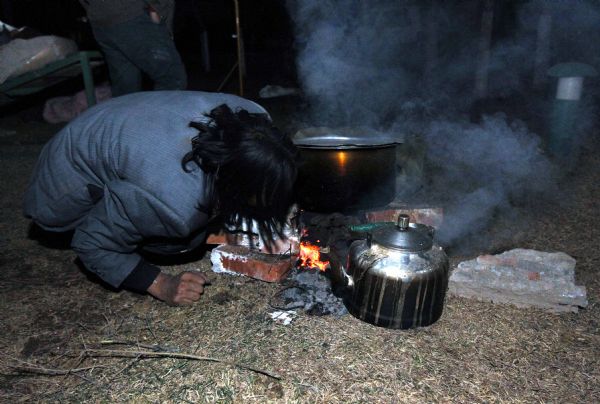 A survivor prepares meal after a quake in Yushu County, northwest China's Qinghai Province, April 14, 2010. 