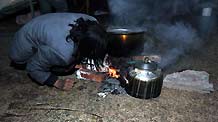 A survivor prepares meal after a quake in Yushu County, northwest China's Qinghai Province, April 14, 2010.