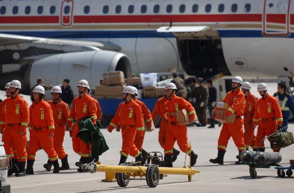 Rescuers prepare to get on the plane leaving for the quake-hit Yushu County at Caojiabu airport, Xining, capital of northwest China's Qinghai Province, April 15, 2010. Xining to Yushu airline was considered 'airline for life' since the 7.1-magnitude earthquake hit northwest China's Qinghai Province early on Wednesday. Thousands of rescuers have been transported to the quake-hit Yushu County since the disaster occured.