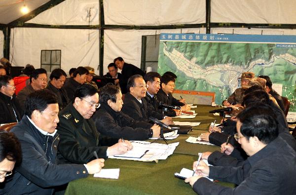 Chinese Premier Wen Jiabao (5th L, front) presides over a meeting on the disaster relief work in Yushu, northwest China's Qinghai Province, April 15, 2010. 