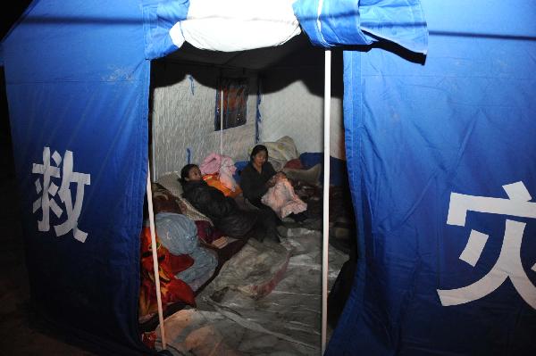 Residents rest in a tent in Tibetan Autonomous Prefecture of Yushu, northwest China's Qinghai Province, April 15, 2010. 