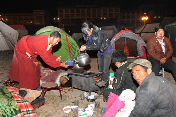 Residents rest in a tent in Tibetan Autonomous Prefecture of Yushu, northwest China's Qinghai Province, April 15, 2010. 