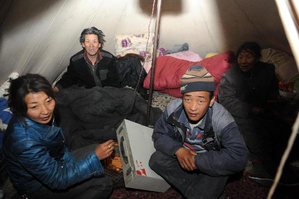 Residents rest in a tent in Tibetan Autonomous Prefecture of Yushu, northwest China's Qinghai Province, April 15, 2010. 