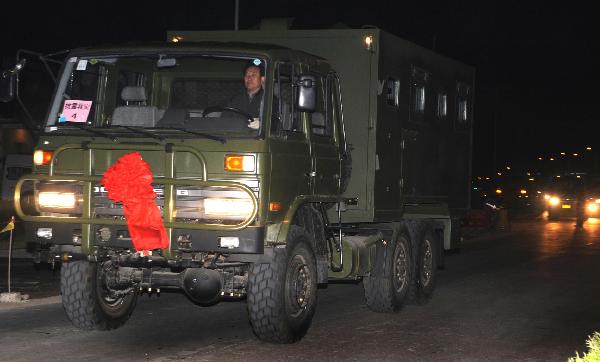 One in an array of some 39 full-equipped plateau proper-functional kitchen trucks set out en route for the quake-jolted zone in Yushu of Qinghai, at Lu'an City, east China's Anhui Province, April 15, 2010. 