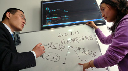 A securities consultant (left) introduces stock-index futures knowledge to a client in Nanjing, Jiangsu Province. The introduction of stock index futures was a milestone in China's equities market to diversify trading instruments. 