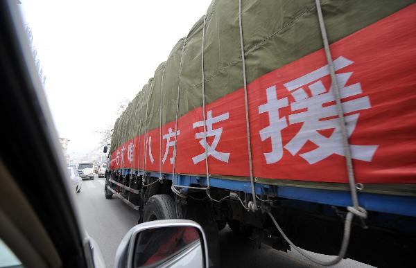 Trucks carrying relief materials are seen in quake-hit Yushu County y,northwest China's Qinghai Province, April 16, 2010. Rescue operations continued in Yushu to save more lives during the'golden 72 hours'since the 7.1-magnitude quake struck here early Wednesday.