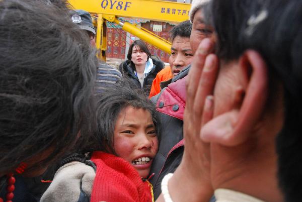 A girl is rescued out of the debris of Minzu Hotel at Gyegu Town of earthquake-hit Yushu County of northwest China&apos;s Qinghai Province, April 16, 2010. She was rescued out of the debris at 14:00 p.m. after 6-hour-effort of members of the China National Earthquake Disaster Relief Team. Rescuers have been doing unremitting efforts to save people&apos;s lives during the &apos;golden 72 hours&apos; since the 7.1-magnitude quake struck Yushu early Wednesday.