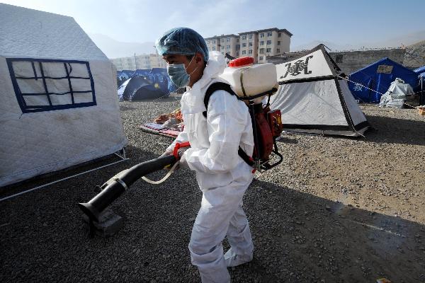 An epidemic prevention worker is engaged in disinfection work at tent area in quake-hit Yushu County, northwest China's Qinghai Province, April 17, 2010.