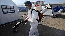 An epidemic prevention worker is engaged in disinfection work at tent area in quake-hit Yushu County, northwest China's Qinghai Province, April 17, 2010.
