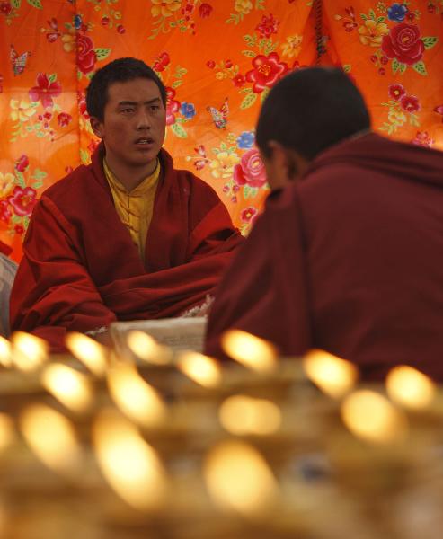 Monks chant prayers for the victims in a tent in quake-hit Gyegu Town of Yushu County, northwest China's Qinghai Province, April 17, 2010. 