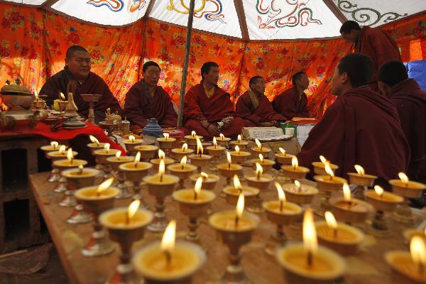 Monks chant prayers for the victims in a tent in quake-hit Gyegu Town of Yushu County, northwest China's Qinghai Province, April 17, 2010.