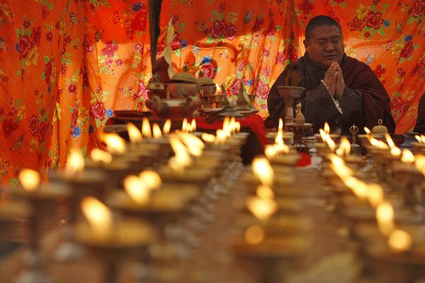 Monks chant prayers for the victims in a tent in quake-hit Gyegu Town of Yushu County, northwest China's Qinghai Province, April 17, 2010.