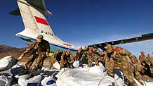Chinese soldiers unload relief supplies from a military cargo plane at Yushu Airport in quake-hit Yushu County, northwest China's Qinghai Province, April 17, 2010.