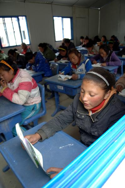 A Grade Four student (R, Front) of the Yushu School for Orphans has a lesson when resuming classes in Gyegu Town, northwest China's Qinghai Province, on April 17, 2010. 