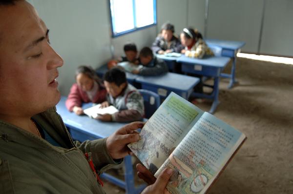 A teacher of the Yushu School for Orphans gives a lesson when resuming classes in Gyegu Town, northwest China's Qinghai Province, on April 17, 2010. 