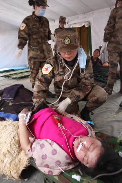 An injured Tibetan ethnic boy receives medical treatment at a military tent at quake-hit Yushu county, northwest China's Qinghai Province, April 17, 2010. 
