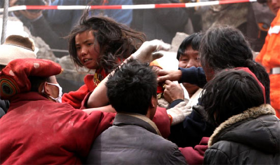 Rescuers and local monks carry a 13-year-old Tibetan girl who was saved after being trapped for 54 hours under the ruins by a 7.1-magnitude earthquake that struck Yushu Tibetan Autonomous Prefecture in Qinghai province early on Wednesday. 