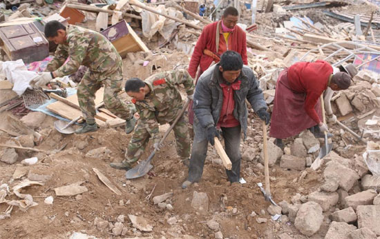 Rescuers and local monks search for victims in the ruins of a 7.1-magnitude earthquake hit Yushu Tibetan Autonomous Prefecture in Qinghai province early on Wednesday. 